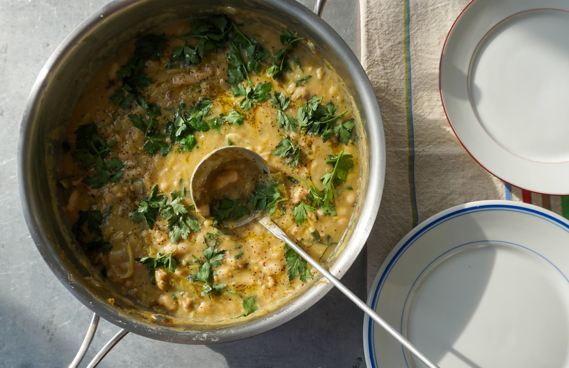 Bean stew in a pan with plates