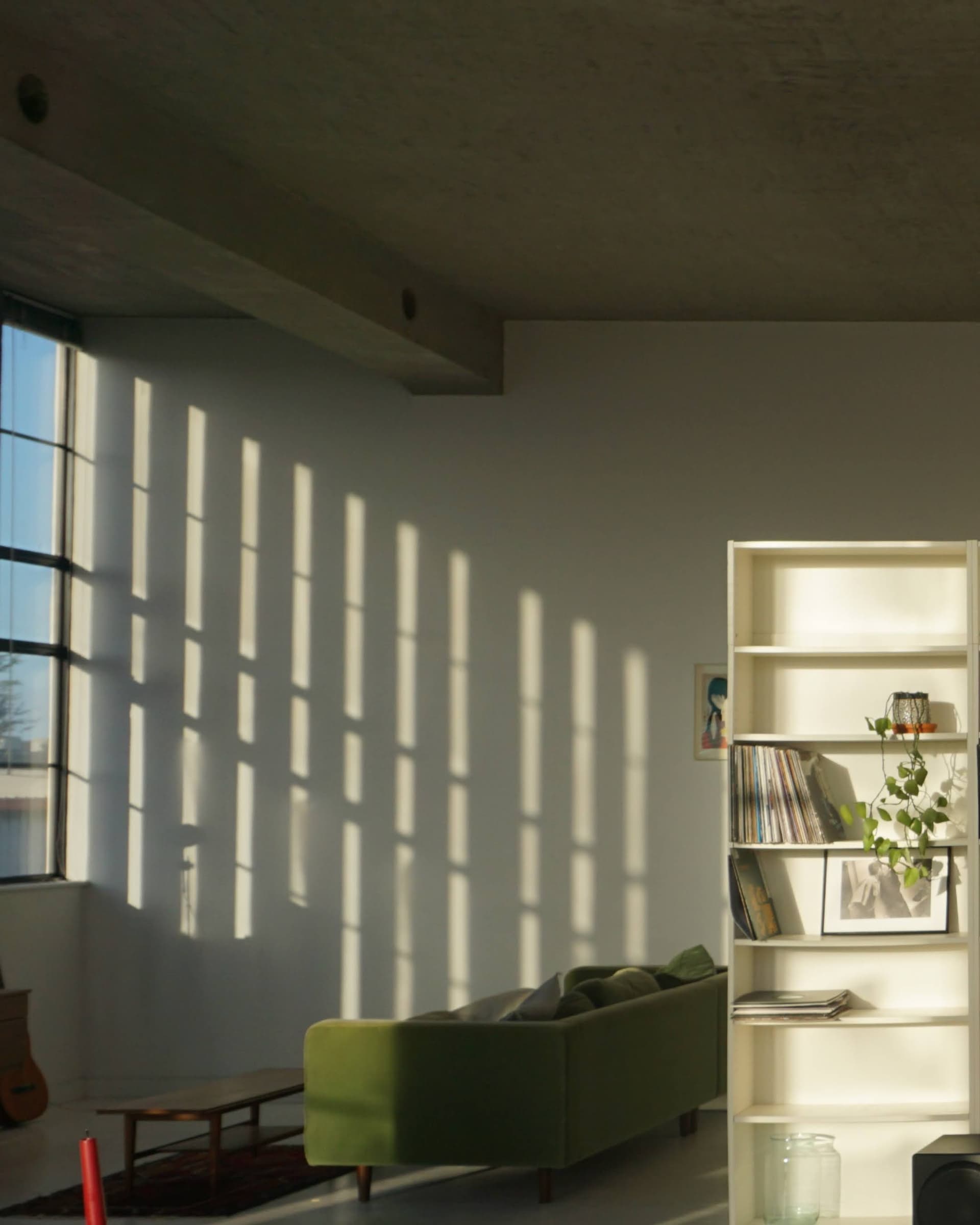 Living space with natural light and green sofa